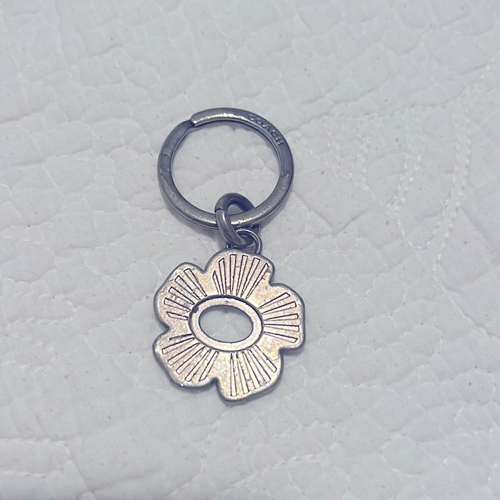 Coach metal flower keychain in used condition